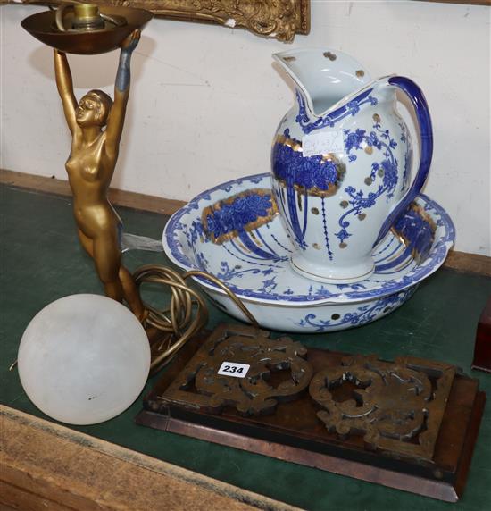 A brass and walnut book slide, An Art Deco lady lamp and blue and white jug and basin set.